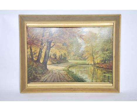 A retro mid century concave woodland scene print being set within a gilt frame