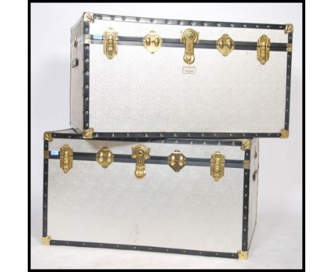 A good pair of 20th century aluminium steamer trunk chests, each with gilt metal clasps and hinges with hinged tops over open