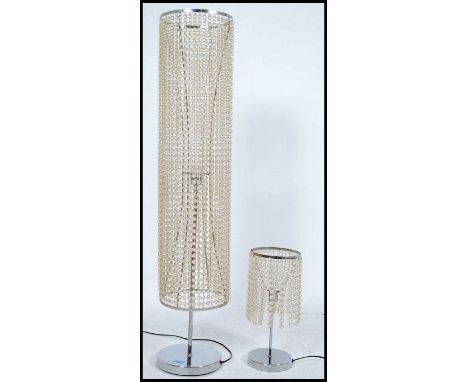 A contemporary floor standing chrome lamp of tall form having many strands of droplets along with a matching table lamp of si