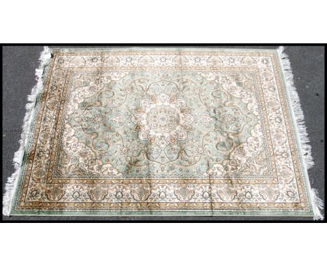 A large Iranian / Persian Keshan carpet - rug having pale green ground with geometric decoration and borders. Measures 1.90m 