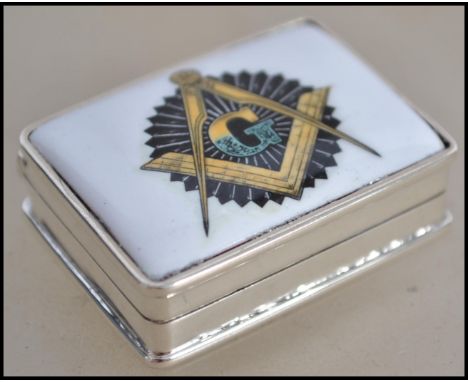 A 20th century silver pill / gents snuff box of circular form having masonic interest with crown finial to the top 