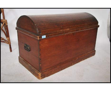 A Victorian style mahogany dome top trunk having panel worked sides with dome top and appointed interior set within. 57cms x 