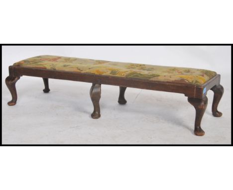 A 19th century oak framed  twin footstool the tapestry upholstered top depicting hunting scenes.  