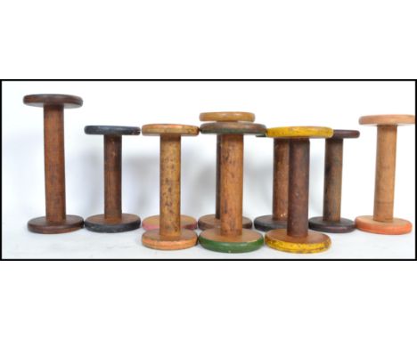 A group of 10 vintage multi coloured painted cotton weaving wooden bobbins from a Lancashire mill, the longest measuring 23cm