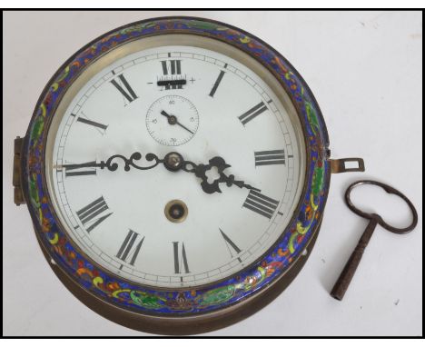 An early 20th century bulk head clock having faceted hands and Roman numeral chapter ring with enamel decoration to edges. Co