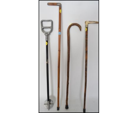 A collection of walking sticks to include a silver collar example with London hallmarks together with another white metal and