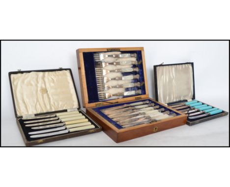 A good set of Edwardian mahogany cased mother of pearl handled silver collar knives together with 2 other EPNS cased canteens