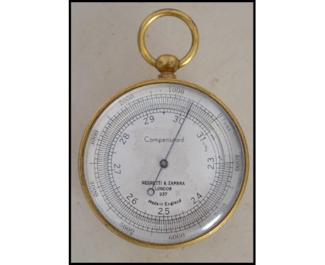 A vintage 20th century Negretti & Zambra compensated aneroid pocket brass surveyor's barometer, diameter 5cm. The silvered fa