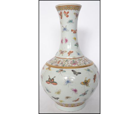 A believed 19th century Oriental ceramic Guangxu famille butterfly pattern vase having a bulbous body with a waisted neck wit