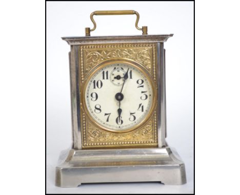 A vintage 20th century German silver white metal carriage clock having handle to top. Measures 15cms high.