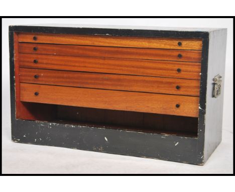 A vintage 20th century pine specimen / tools cabinet having multiple pull out drawers with handles and a painted ebonised fin