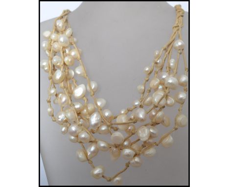 A vintage multi strand baroque pearl necklace consisting of many strands of pearls with a claw clasp.