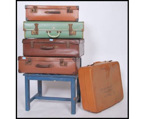 A vintage wooden painted luggage rack raised on squared legs together with a harlequin stack of vintage suitcases dating from