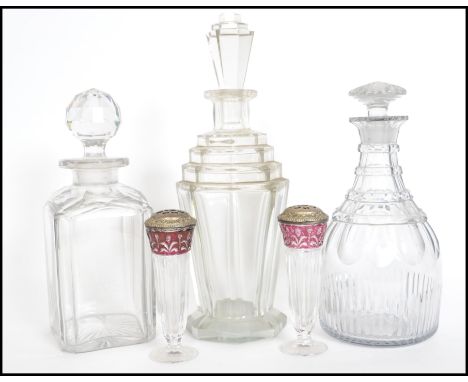 A stunning early 20th century Art Deco glass decanter with stopper along with two other cut glass decanters and a pair of gla