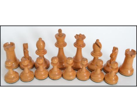 A vintage 20th century carved ebony and box wood chess set held within a wooden box with sliding lid. King measures 9.5 cms h