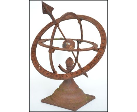 A vintage 20th century cast iron armillary sundial with central arrow and a Roman numeral chapter ring.