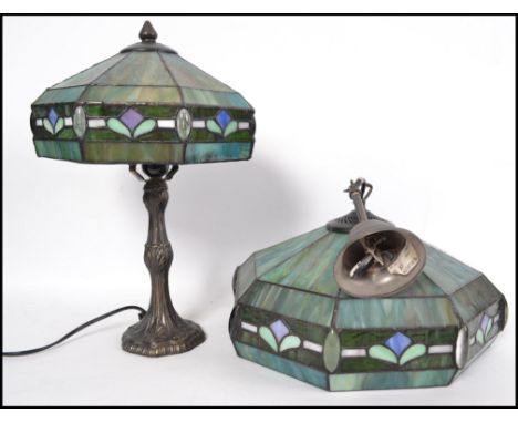 A contemporary stained and leaded glass table lamp with octagonal coloured glass shade together with a matching ceiling lamp