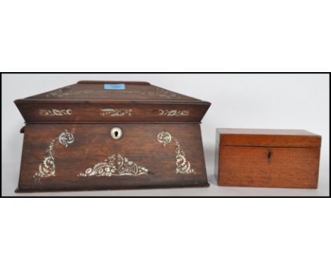 A 19th century Georgian rosewood and mother of pearl inlaid tea caddy having appointed interior within sarcophagus shaped bod