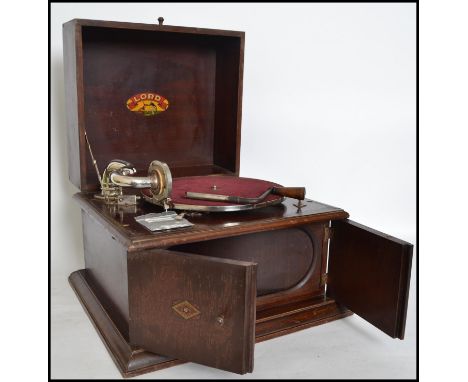 A vintage early 20th century cased table top Gramophone by Lord, the top opening to reveal the Lord Suiza logo, doors to fron