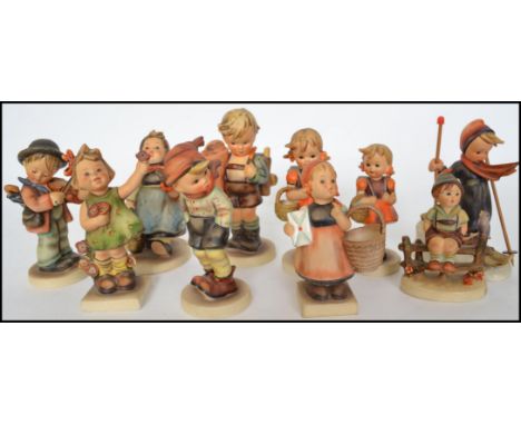 A large collection of vintage Goebel West German Hummel figurines to include Skier, Wayside Harmony, School Girl, Meditation,