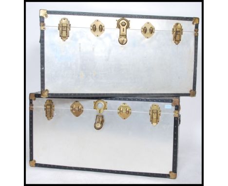 A good pair of large 20th century silvered panel steamer trunk chests, each with gilt metal clasps and hinges with hinged top