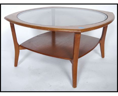 A vintage retro 20th century atomic teak wood hex topped  coffee table, drop in glass top with lower under tier. Measures 45c