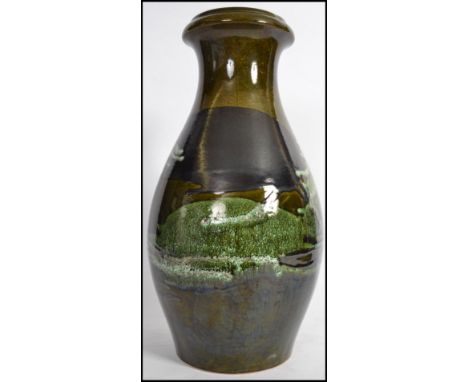 A tall West German Sheurich - Kermatik fat lava floor vase / stick stand on green ground over glazed with natural organic col