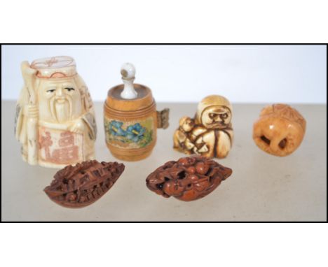 A Chinese bone netsuke figure of an elder with character marks to the base together with resin nut netuske, and faux ivory re