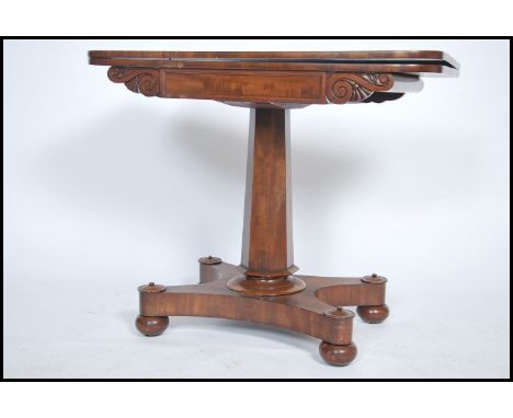 A Regency 19th century mahogany games / card table being raised on a quadruped base with inverted tapering hexagonal column s