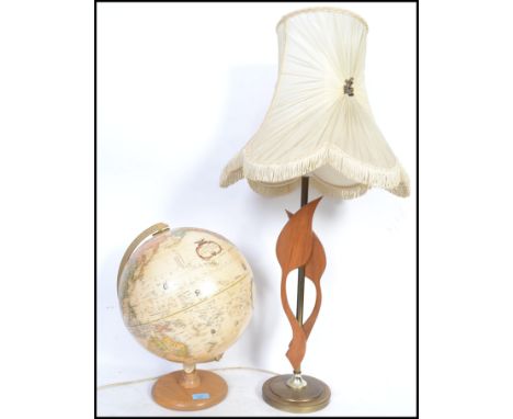 A vintage teak wood retro globe together with a retro brass column table lamp 