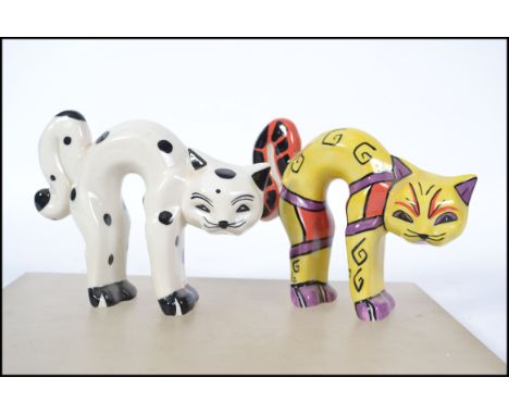 Two Lorna Bailey ceramic pottery cats in arched stretching positions both signed one limited edition 29/50. Measures 13cms hi