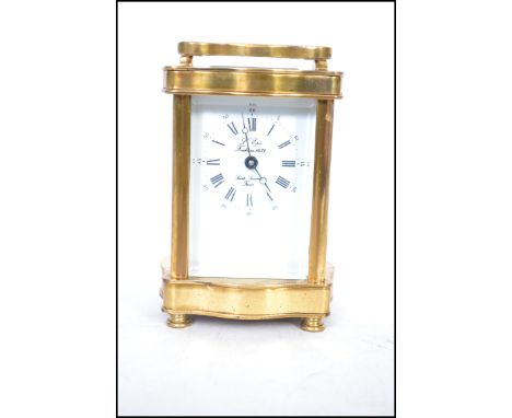 A brass cased carriage clock with roman numeral chapter ring with the dial marked for L'Eipe - Saint Suzanne France. Serpenti