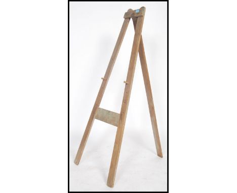 A vintage 20th century Triang artists folding easel with plaque to top.