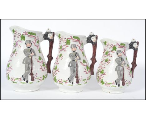 A set of 3 mid 19th century Staffordshire Crimean war jugs of graduating form. Each with trunk and lion mask handles with sol