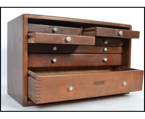 A cased 20th century engineers toolbox with fall front having sectional drawers within having some tools etc