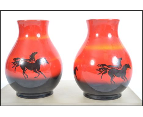 A pair of mid 20th century Sylvac flambe vases in the wild horses pattern of bulbous form being stamped and labelled to base.