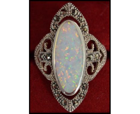 A large silver and opal ladies dress ring of contemporary form being complete in the original presentation case