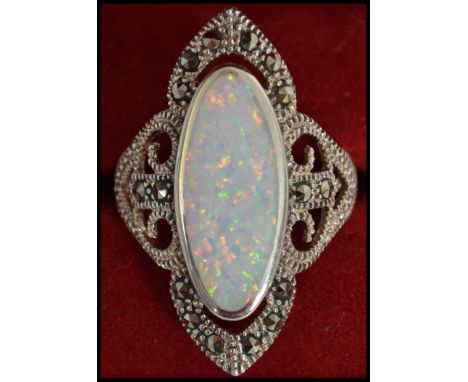 A large silver and opal ladies dress ring of contemporary form being complete in the original presentation case