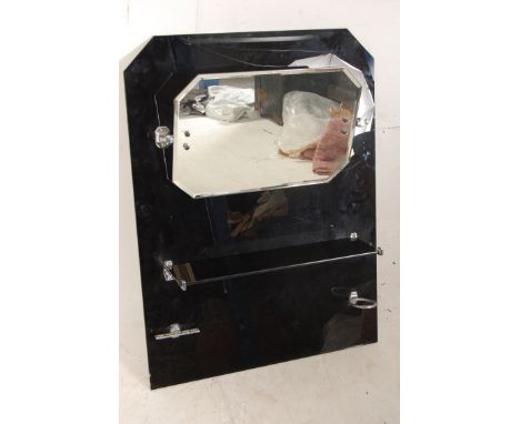 A 1930s Art Deco black glass bathroom mirror with original chrome fittings and glass shelf in good condition.