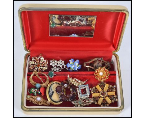 A collection of vintage costume jewellery brooches to include cameo, rhinestone spray, porcelain floral, along with a silver 