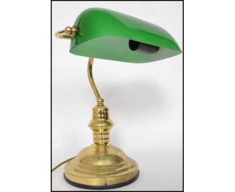 A 20th century contemporary green glass and brass bankers desk lamp having glass rectangular shade that adjusts 