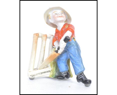 A rare early 20th century Kinsella ceramic figurine of a child with a cricket bat in front of stumps with notation to side Th