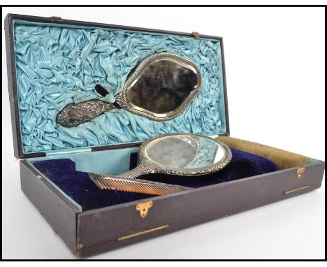 A silver hallmarked cased ladies vanity brush set by Walker & Hall. The harlequin set to include a  mirror and a brush,a  com