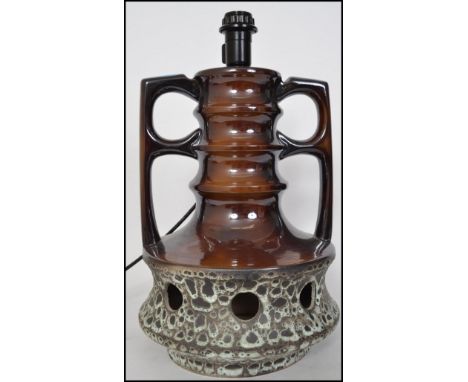 A retro 20th century twin handled West German table lamp of tall form having a cream and brown speckled glazed  with pierced 