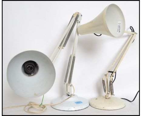Two vintage 20th century industrial anglepoise lamps raised on circular bases with pendant shades having a painted white fini