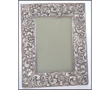 A silver hallmarked photograph frame with glass front and easel back