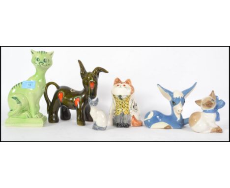 A group of ceramic cats and donkeys to include Rye Monastery cat, Kilkenny cat, Szeilfr cat, Royal Copenhagen cat, Devon Fat 