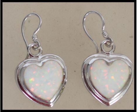 A pair of ladies contemporary silver and opal adorned earrings of heart shape complete in the presentation case