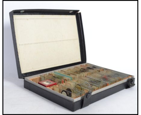 A good collection of scientific glass microscope slides complete in a numbered slide storage case with button fastening lid.
