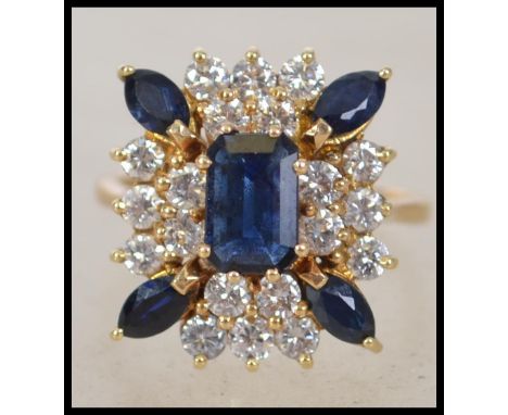 A stunning Art Deco 25 stone Sapphire and Diamond rectangular cluster ring. The central 7.4 x 4.8mm step cut sapphire, 5 bril